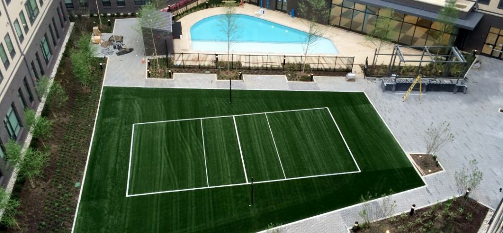 An overhead shot of a pickleball court done in artificial turf.