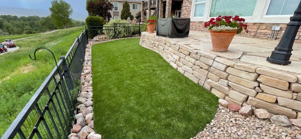Quality Artificial Grass In A Well-Landscaped Yard.