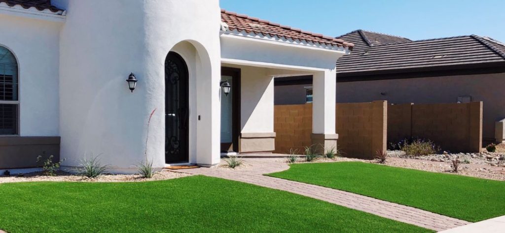 A Beautifully Landscaped Front Yard With Artificial Grass.