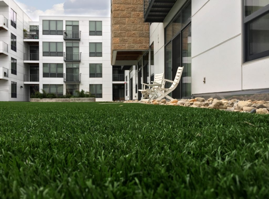 Close Up Of Artificial Grass Outside An Apartment Complex