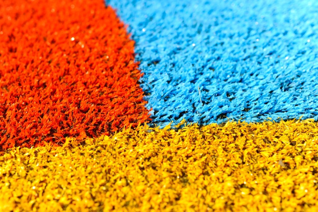 Red, Yellow, &Amp; Blue Playground Grass Close Up